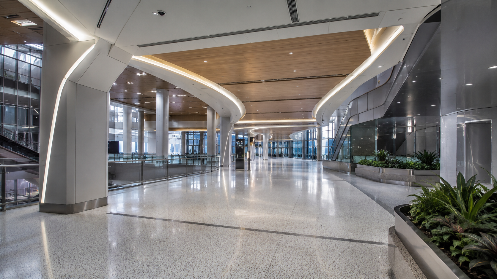 Contemporary transport hub interior featuring architectural lighting, illuminated circulation areas and bright glare-free lighting supporting passenger safety and way-finding.