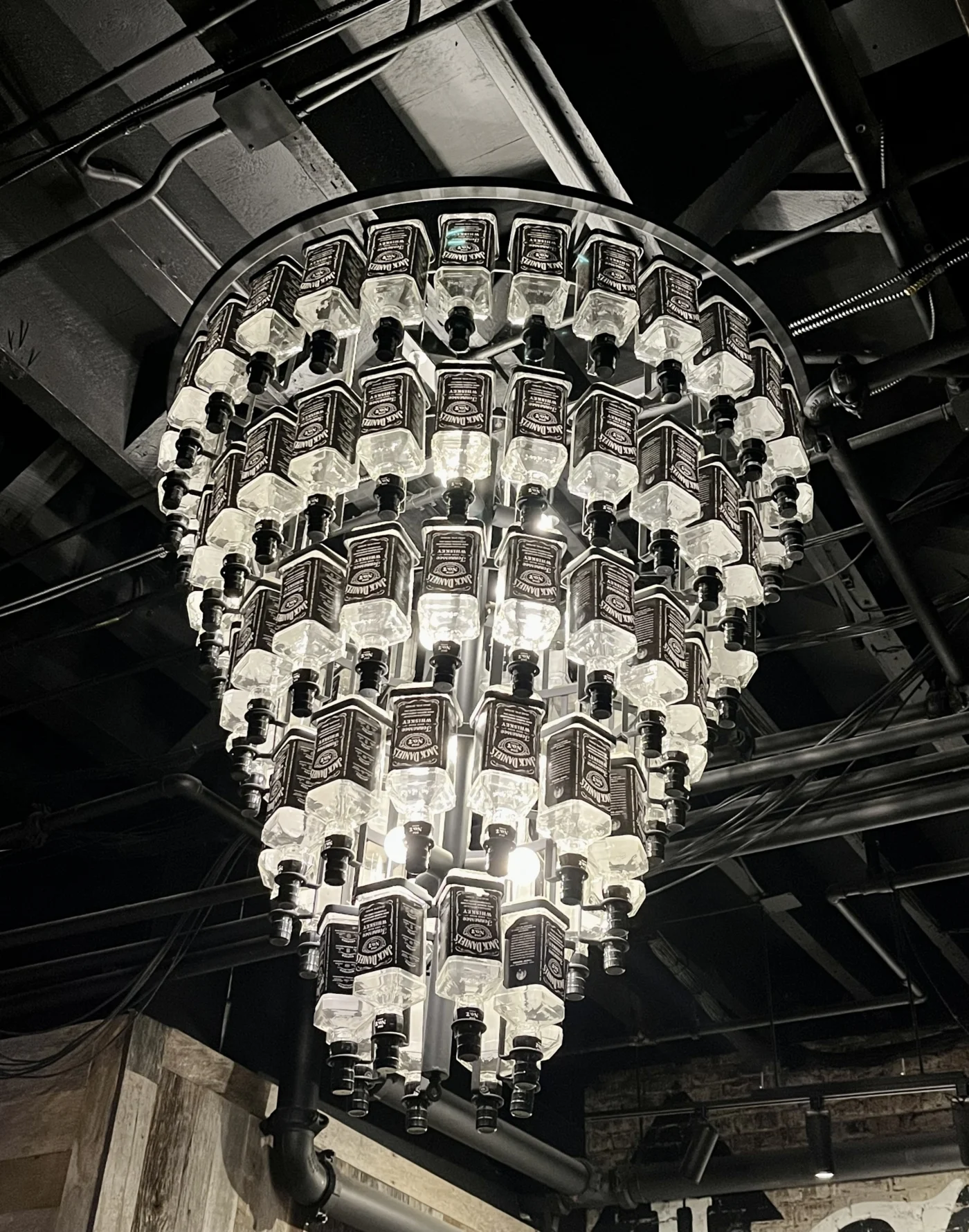 Jack Daniel’s bottle chandelier in bar interior