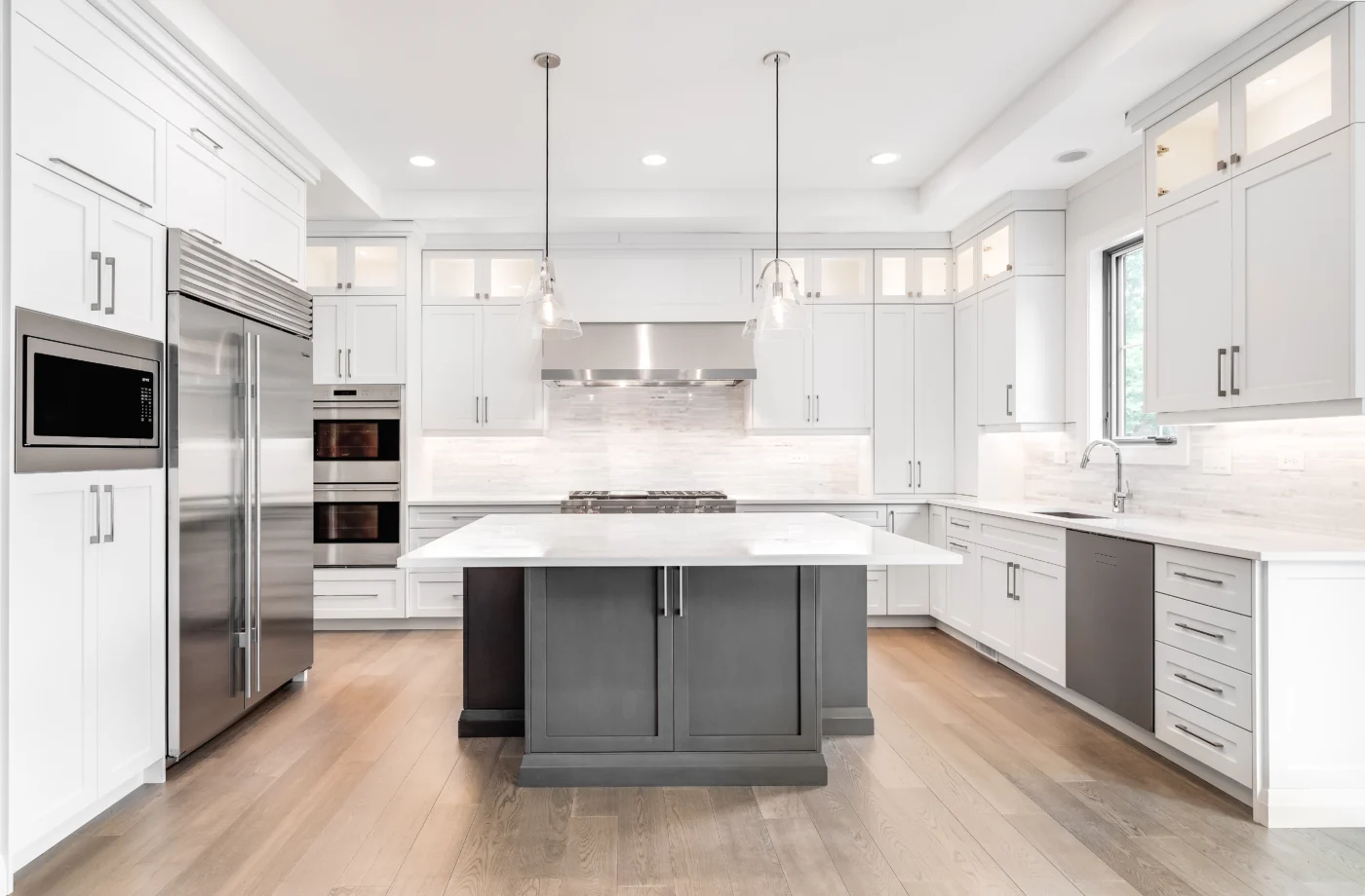 Contemporary kitchen with pendant and recessed lighting