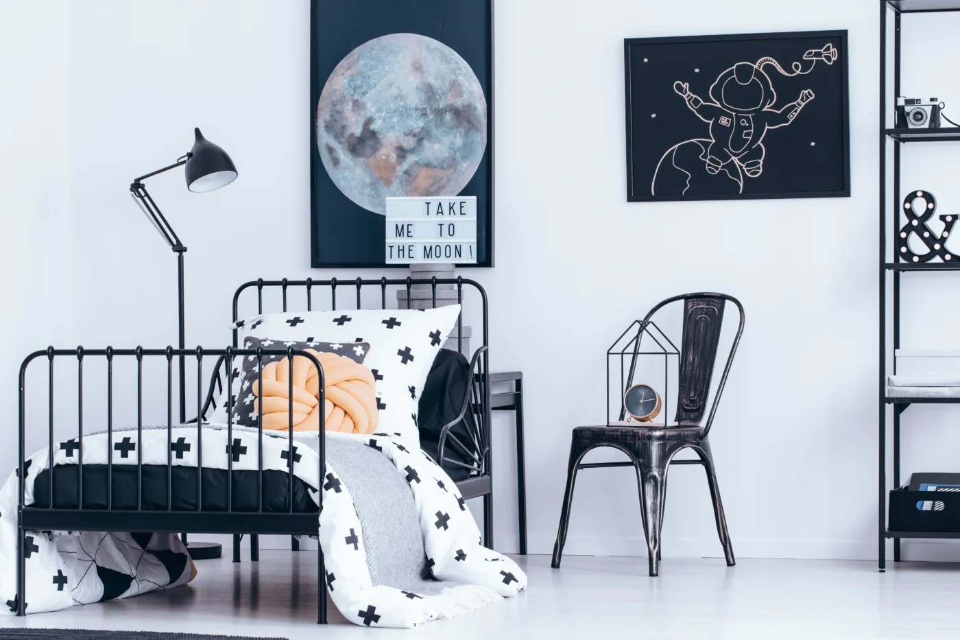Monochrome bedroom with statement task lighting