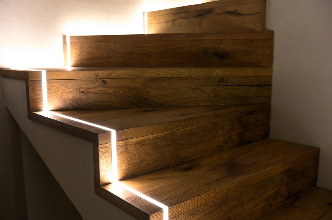 Modern LED stair lighting in wooden staircase